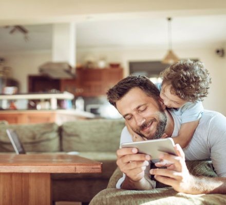 man holding phone with child